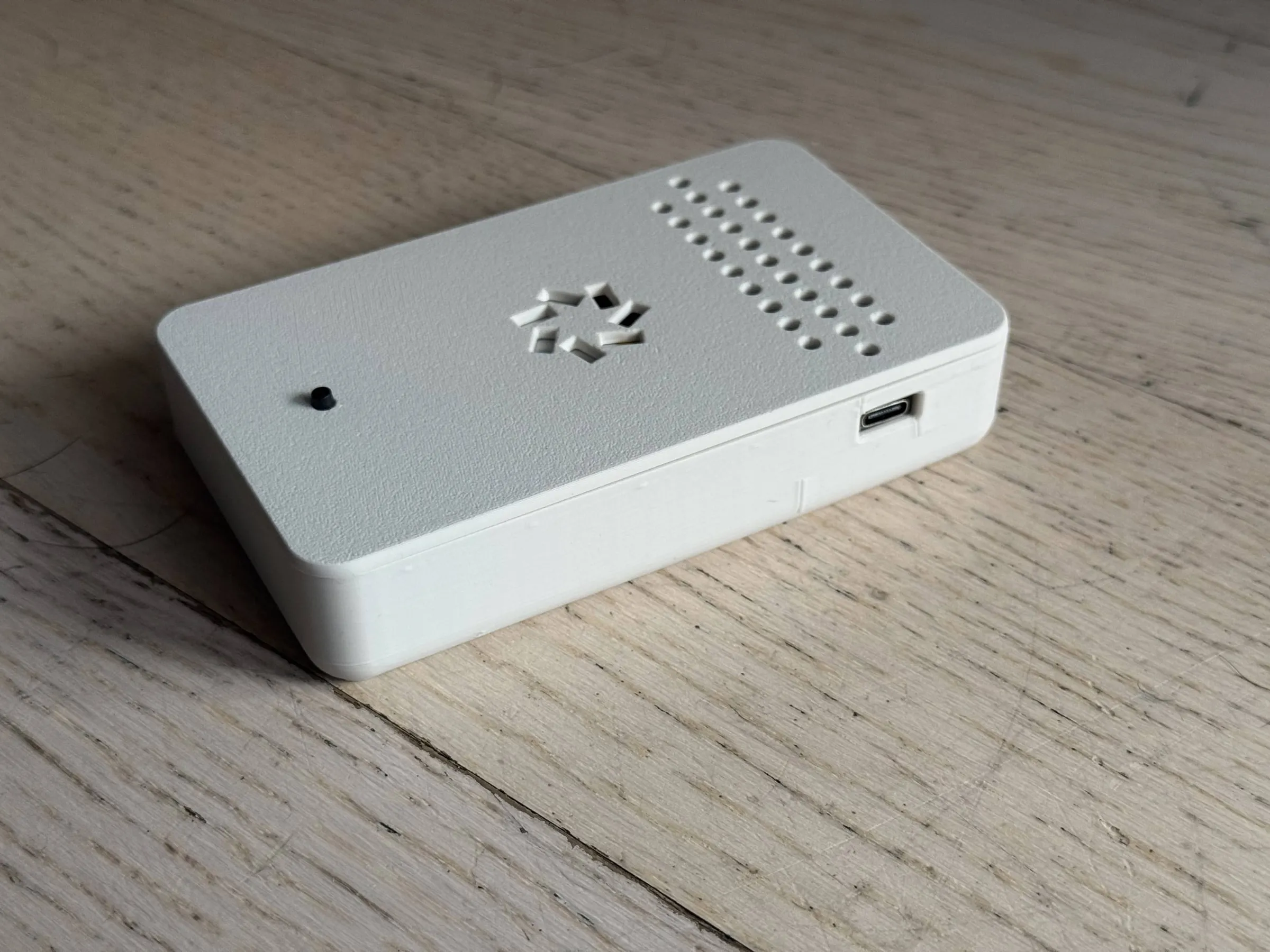 The mini lying face down, with a USB-C port in the side of the case