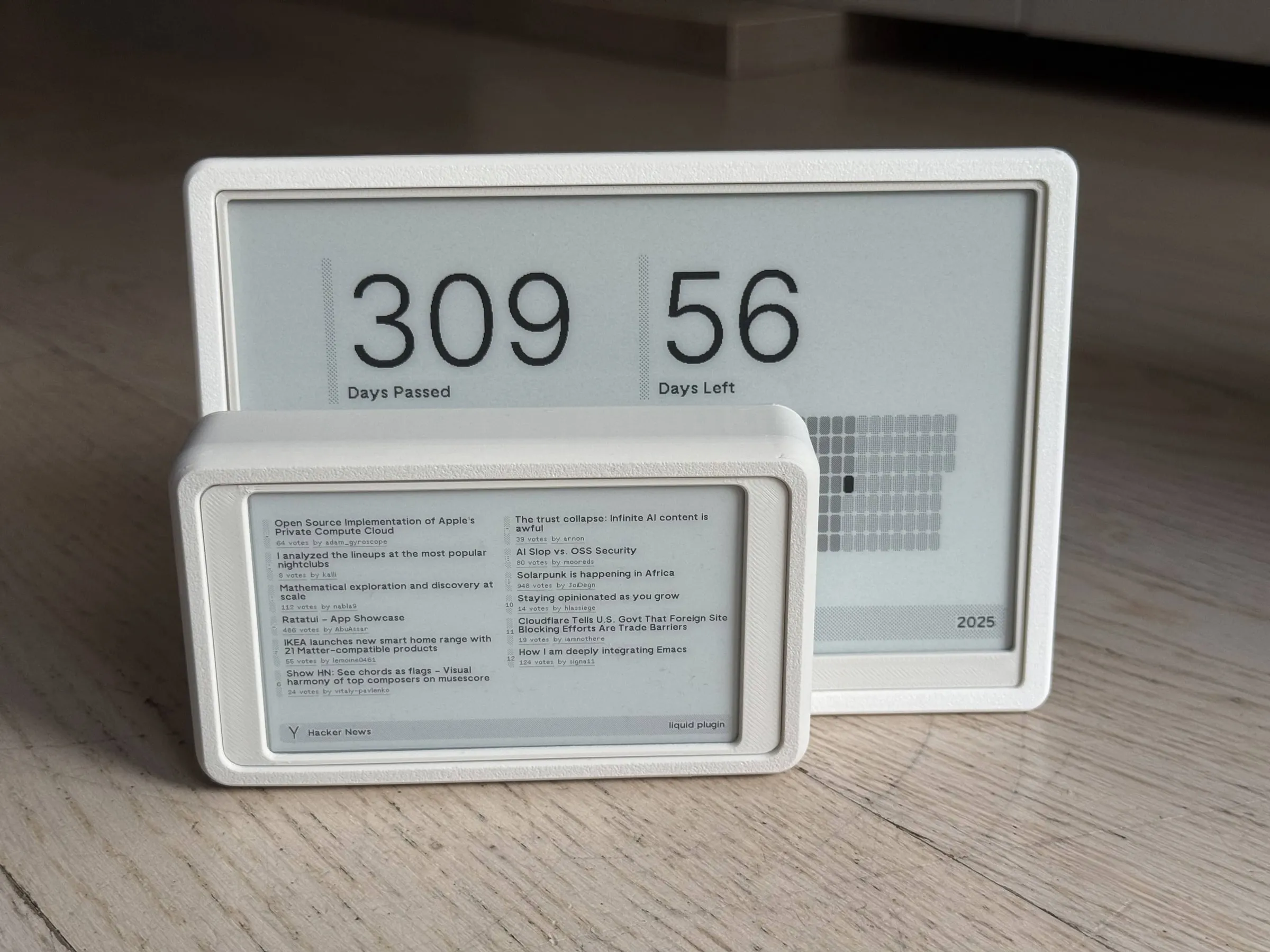 The mini standing in front of the larger display, which is wider and taller